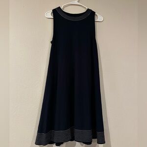 Sleeveless navy dress in XS with white intricate embroidery at the collar & hem.